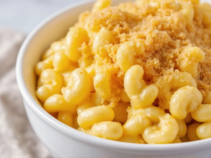 Creamy mac and cheese in white bowl with crispy breadcrumb topping