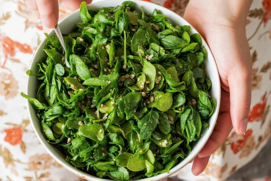 Five types of African greens laid out on a wooden table