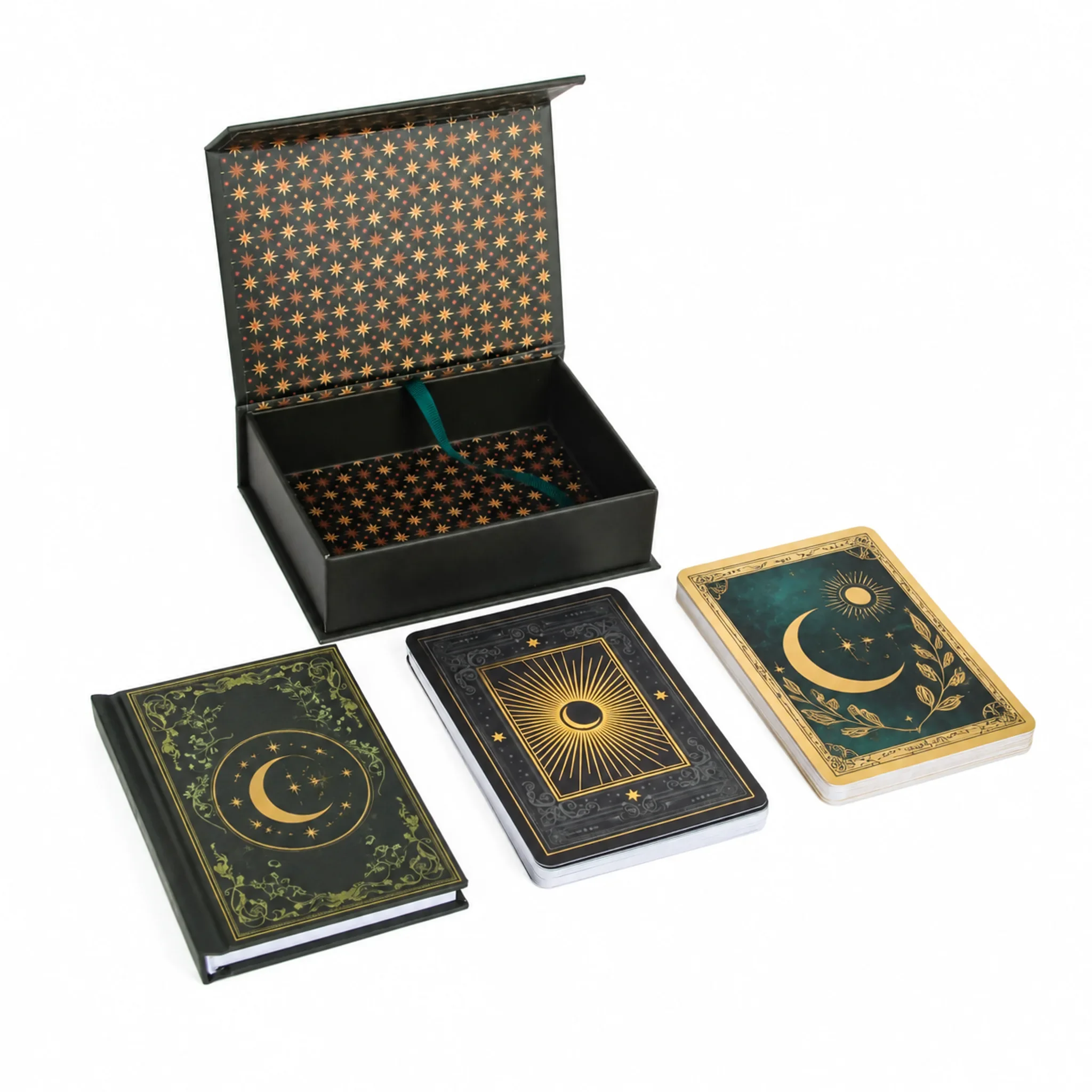 Custom tarot cards with guidebook sample set: open black flip box with star printed liner and teal ribbon, a gilded deck and a foil stamped guidebook