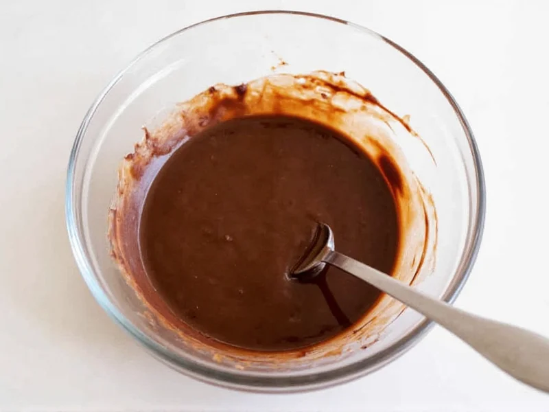 Melting chocolate for homemade Reese's cups in glass bowl