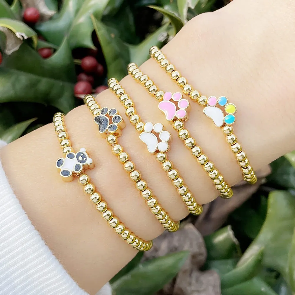 

Enamel Dog paw panda charm with gold beaded elastic bracelet for women