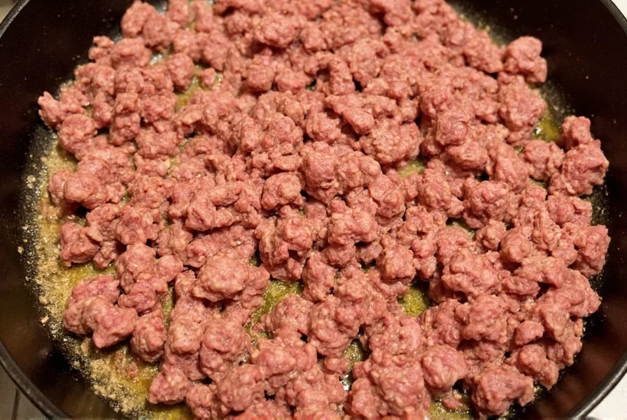 Perfectly browned ground beef in cast iron skillet for chili recipe