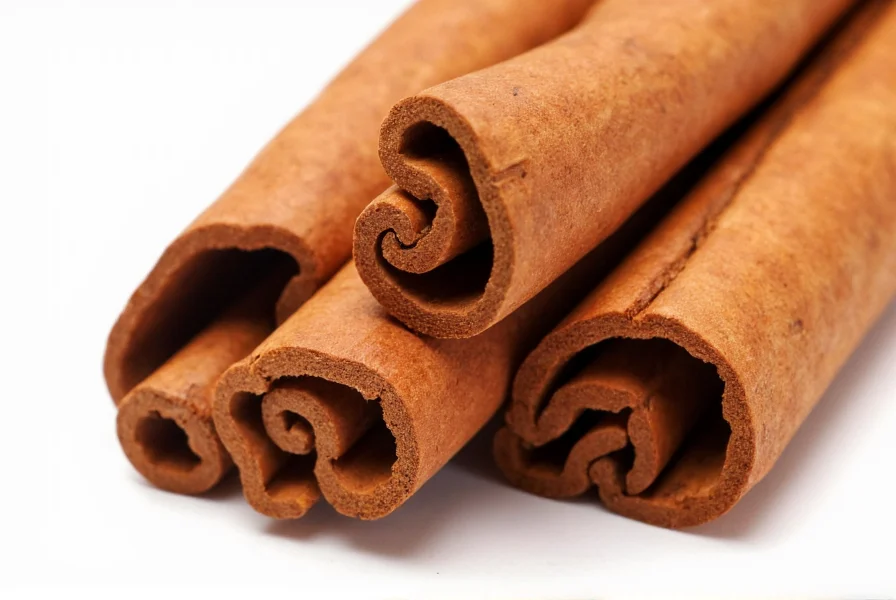 Close-up of fresh cinnamon sticks showing rich reddish-brown color and intact bark