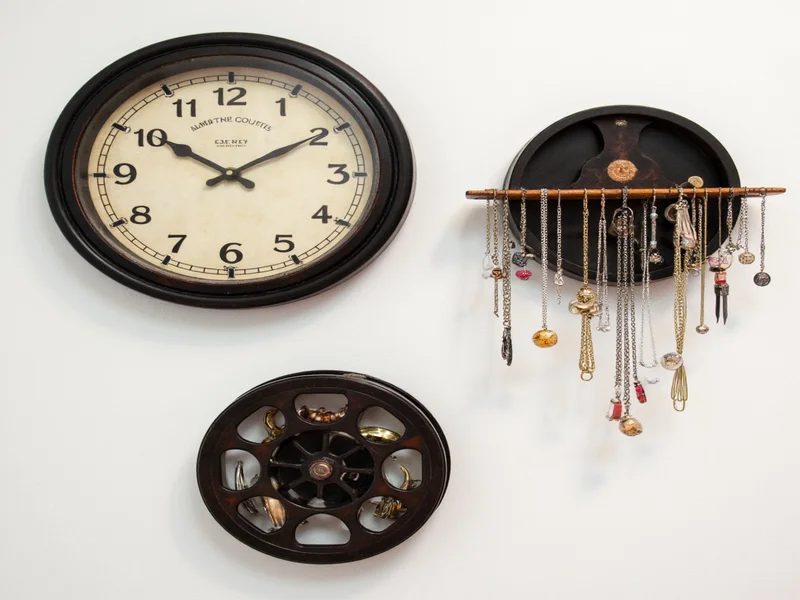 Three repurposed film reels showing clock, shelf, and jewelry organizer projects