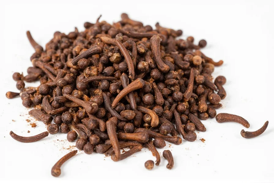 Clove tea preparation showing whole cloves steeping in a clear glass teapot with steam rising