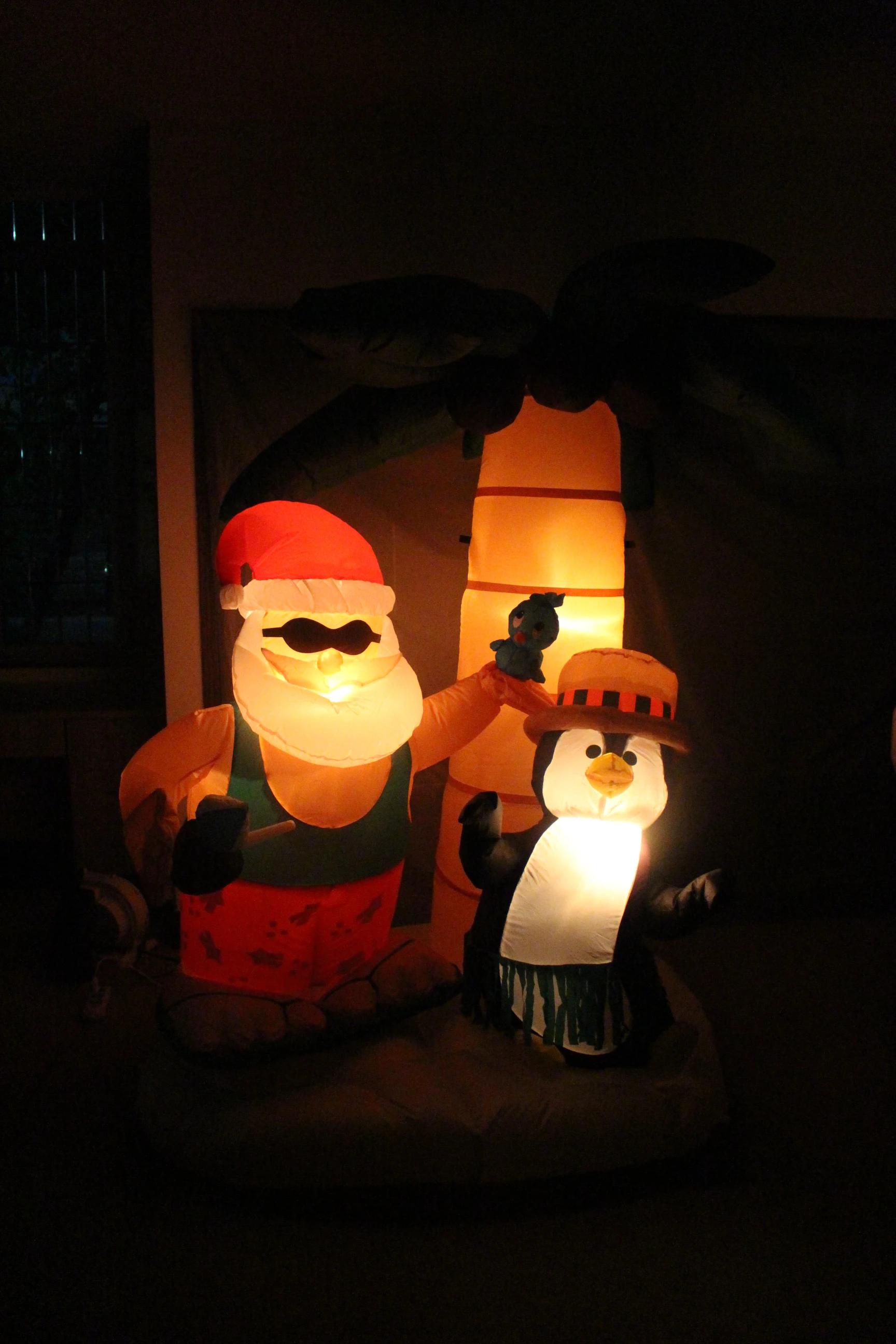 
210cm/7ft inflatable santa claus with a penguin under a palm tree and with internal lights for christmas decoration 