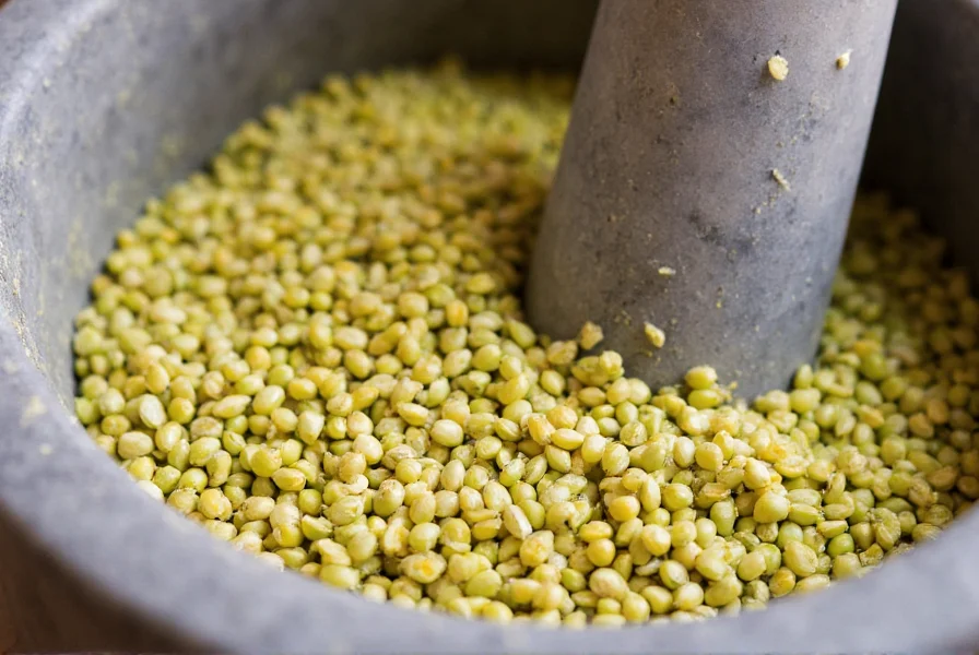 Close-up of fresh fennel seeds being crushed in a mortar and pestle for tea preparation