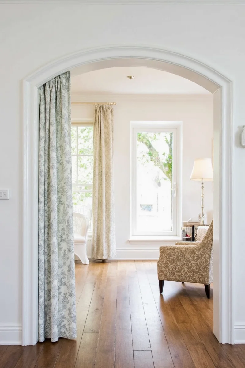 Dark blue velvet curtains over arch
