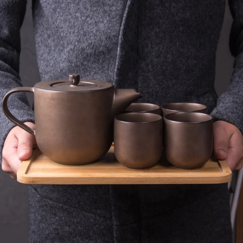 

Delicate wine red porcelain tea set, afternoon tea using teapot cups. European coffee pot set with bamboo tray