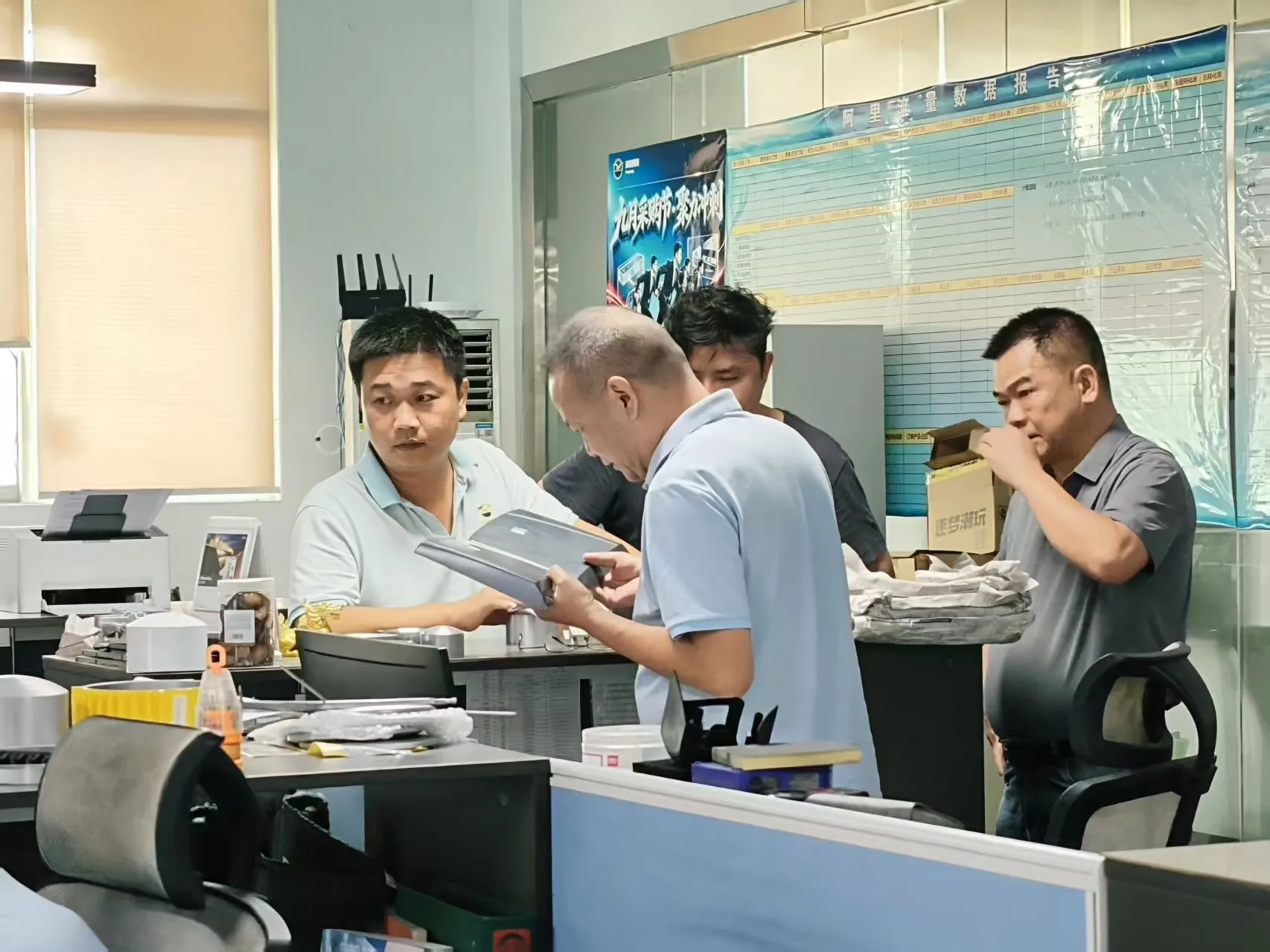 Project review at Runpeng with the job folder open while a manufacturing process is decided