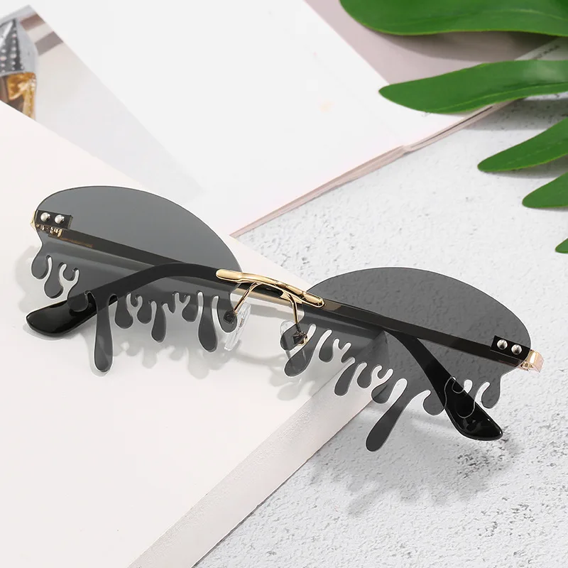

Fashion 2021 Rimless Tinted Fire Dripping Shape Women Ladies Sunglasses, Colors