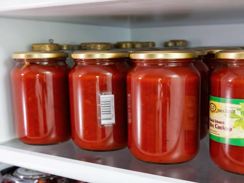 Homemade ketchup jars in refrigerator with label