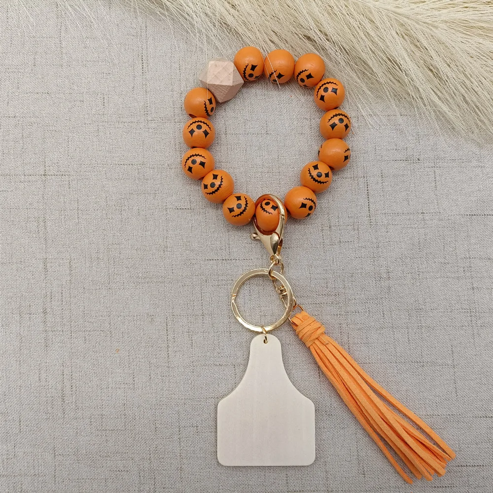 

Christmas Halloween Hot Sale White and Orange Wooden Bead Bracelet Keychain with Tassel