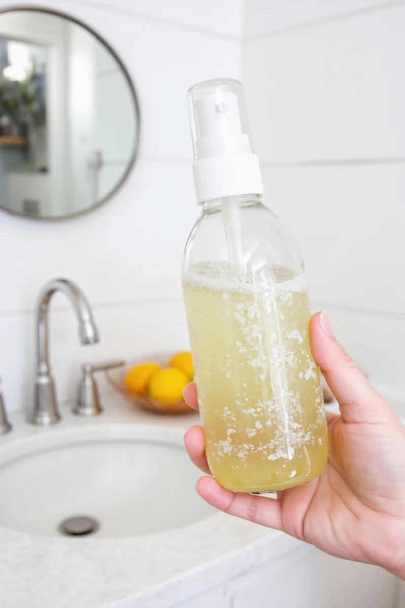 Organized shelf of homemade cleaning supplies