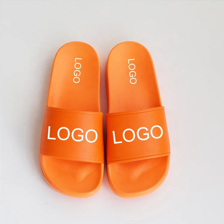 

2021 OEM New Arrival Summer orange color Pvc Strap Hot Selling flat women embossed logo sandals slide slippers men unisex