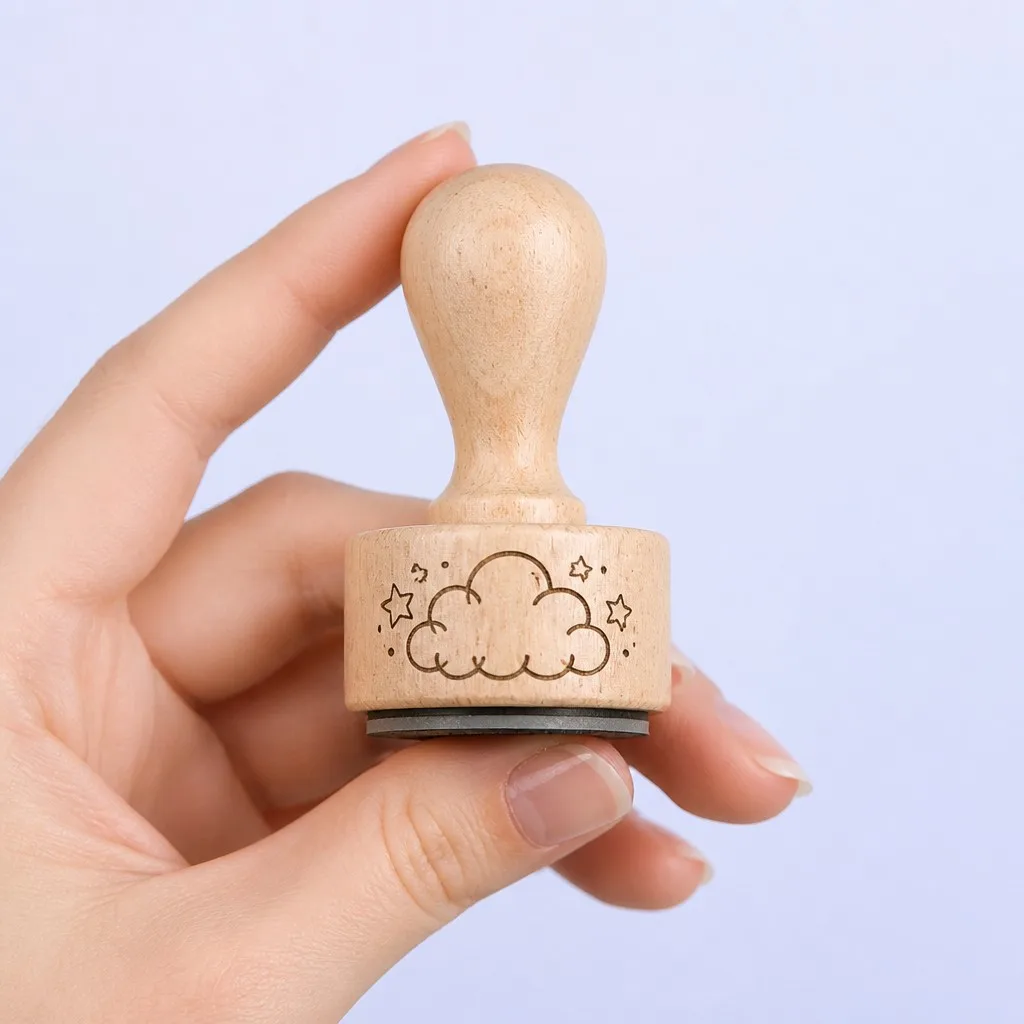 A hand holding a small journaling stamp to show its size