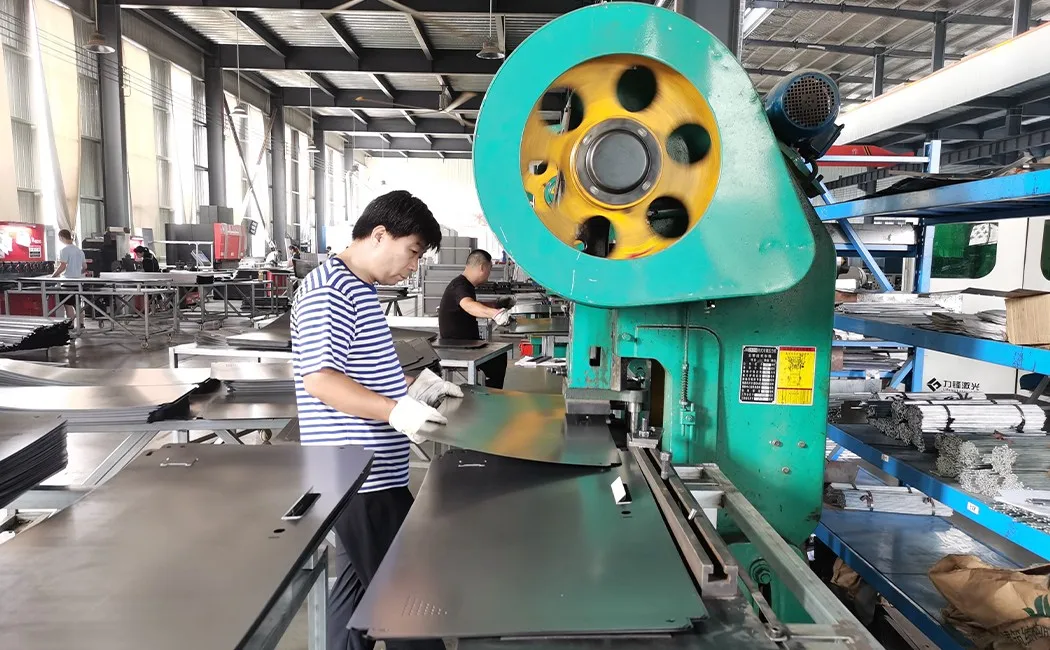 CNC punch press stamping ventilation and hinge holes in steel locker panels — manufacturing process
