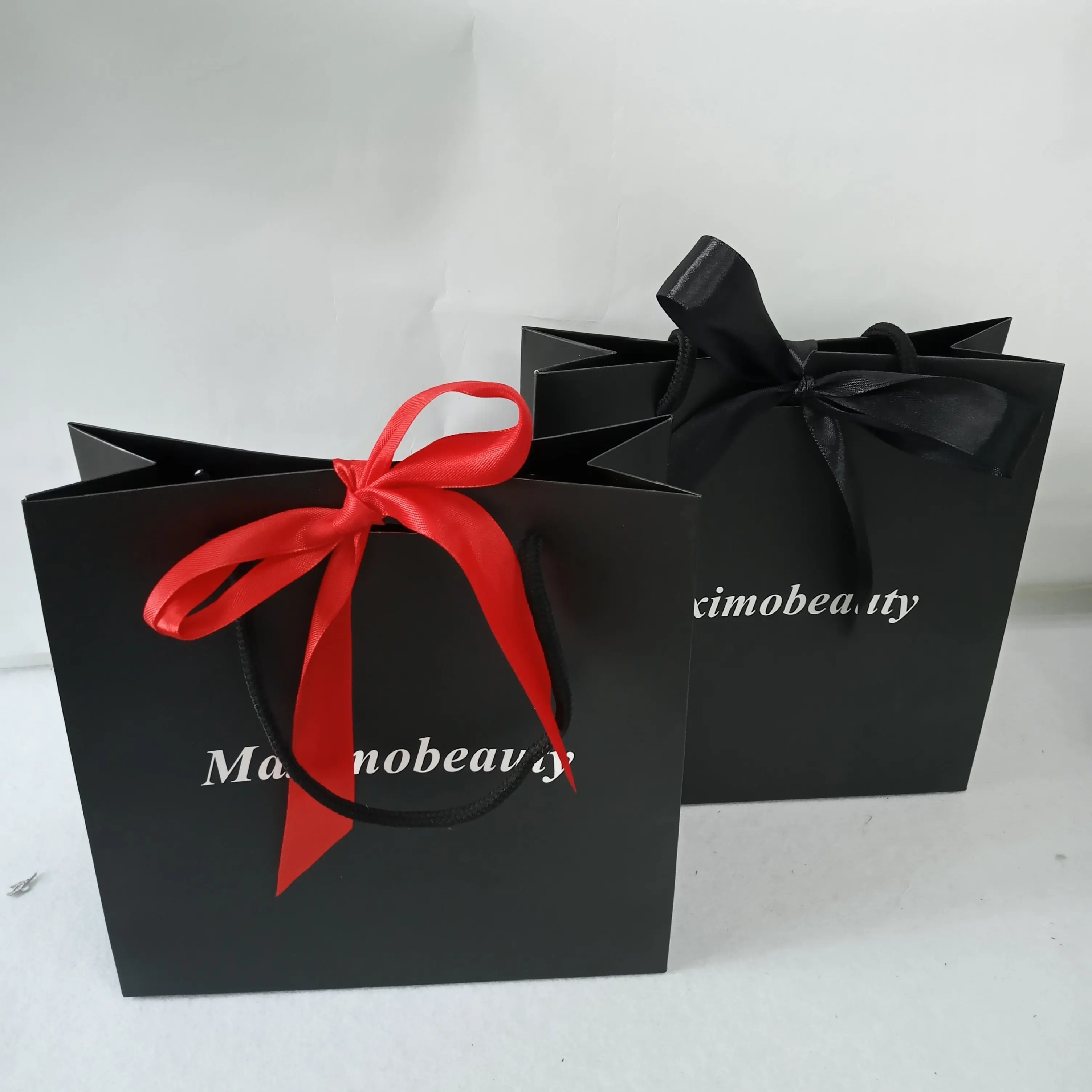 

Custom Logo Printed Luxury Black kraft paper bag Matt Laminated Shopping Bag With Ribbon Bow