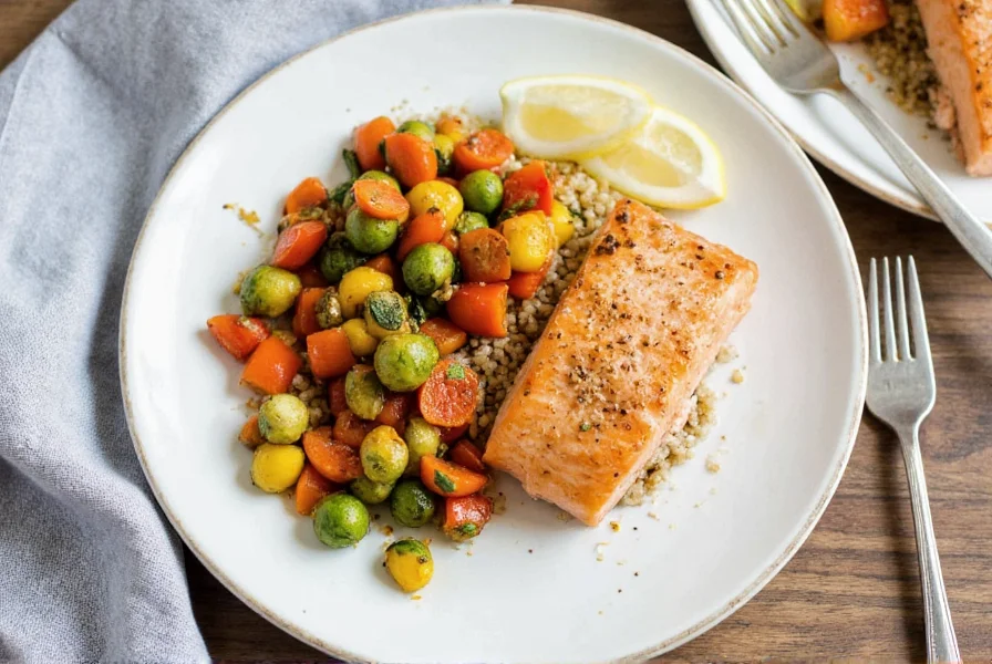 Plated lemon pepper salmon with roasted vegetables and quinoa