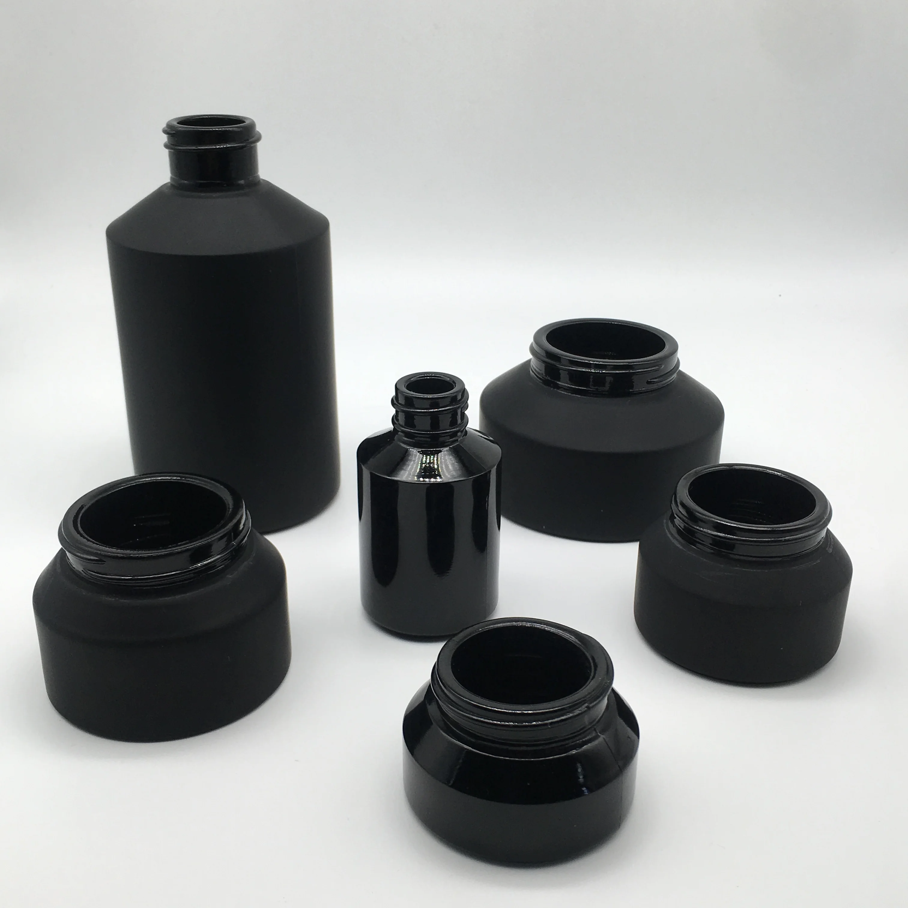 Factory hot sell cosmetic packaging frosted black glass bottle and jar with bamboo lid