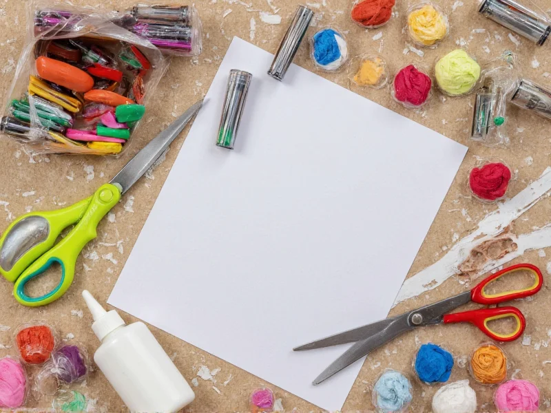 Essential hobby craft tools scissors glue recycled materials on workspace