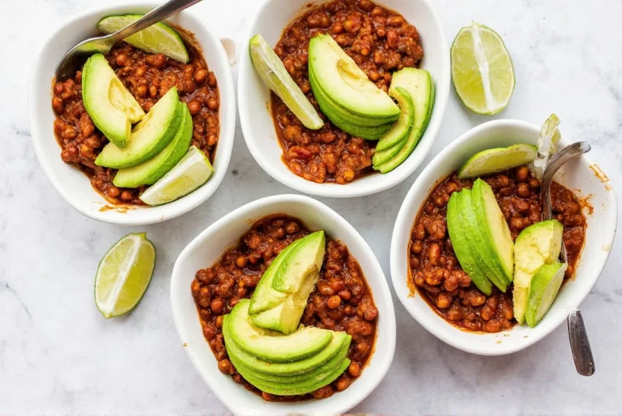 Whole30 chili meal prep containers with fresh avocado slices and lime wedges, ready for weekly lunches