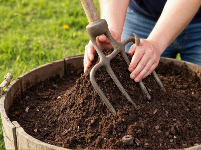 Hands turning compost in backyard bin with pitchfork
