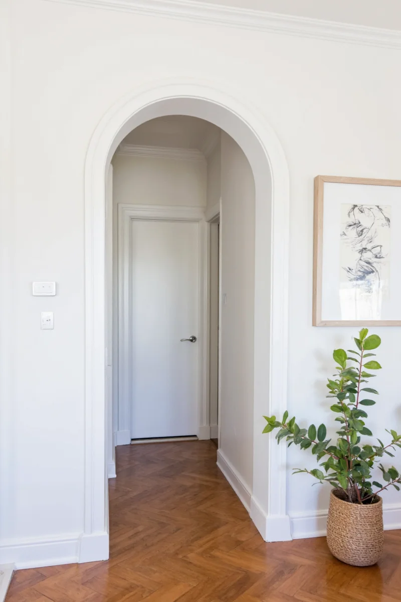 Arched doorway with built-in shelves for toy storage