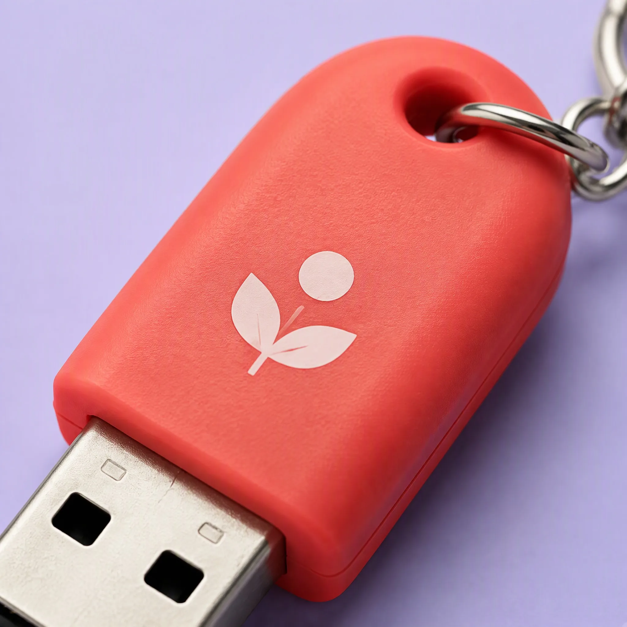 Macro Close-Up on Soft-Touch Matte Coral Silicone Housing, Silk-Screened Sprout Logo, and Lanyard Hole