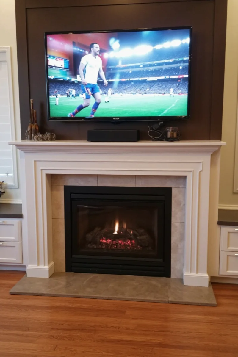 Samsung The Frame TV displaying art above fireplace
