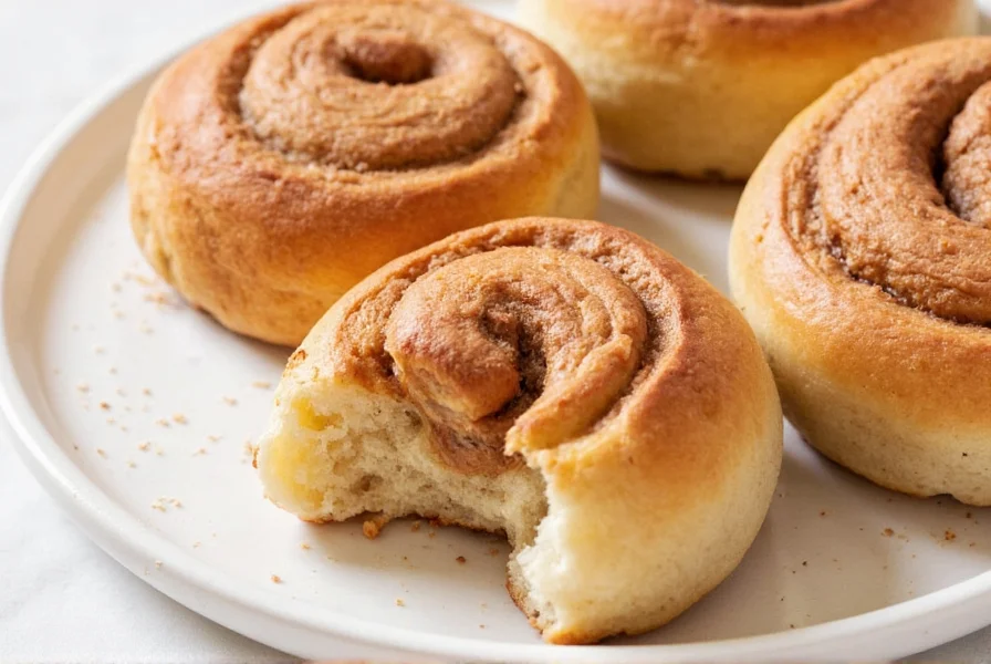 Perfectly sliced cinnamon bun roll showing even cinnamon distribution before baking