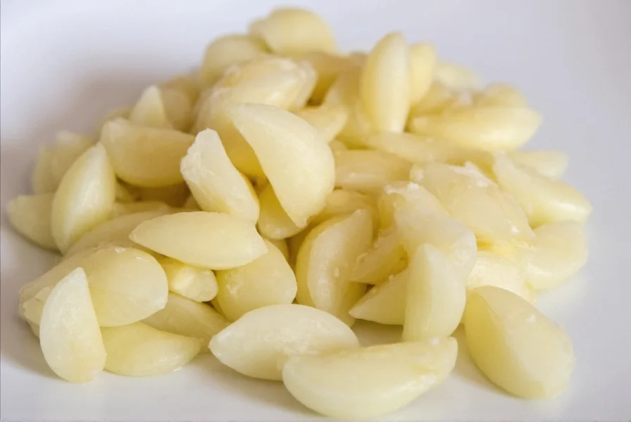 Chef's hand measuring minced garlic in a teaspoon for recipe accuracy