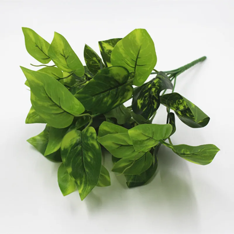

Artificial green wall hanging decorative green leaves artificial plants outside. artificial plant
