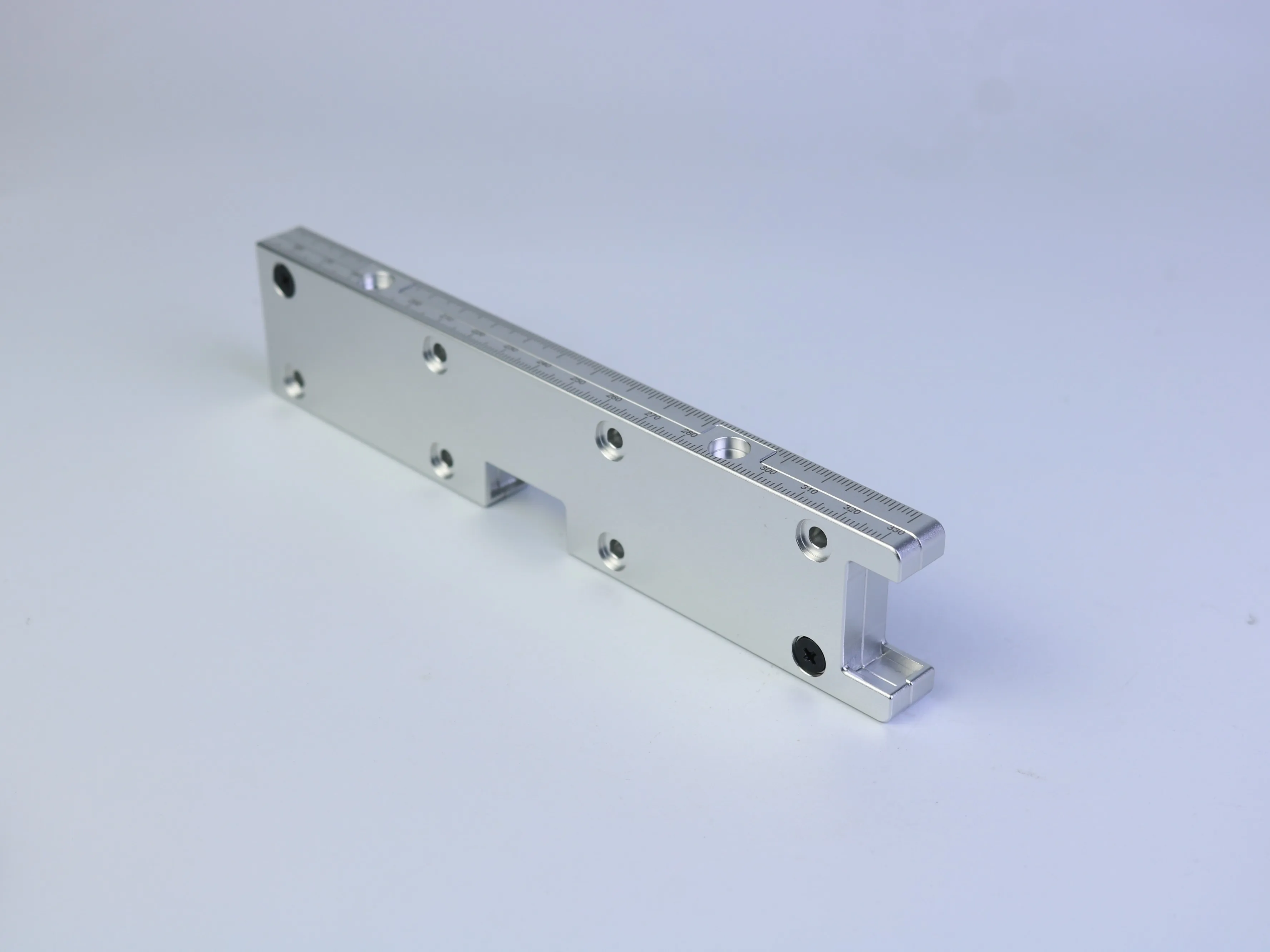 Silver CNC machined mounting bracket with multiple mounting holes and stepped support features