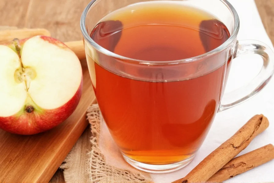 Homemade apple cinnamon tea preparation showing fresh apple slices simmering with cinnamon sticks in a glass pot