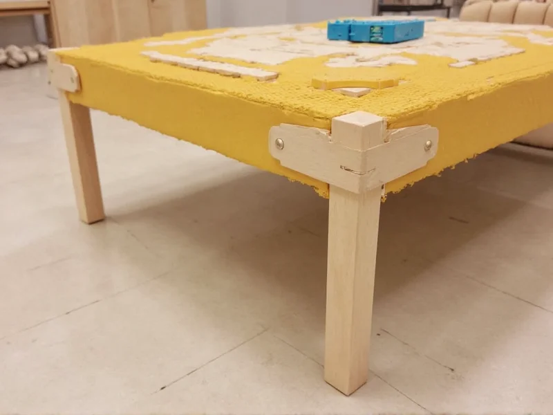 Reinforced corner braces on underside of Lego table frame