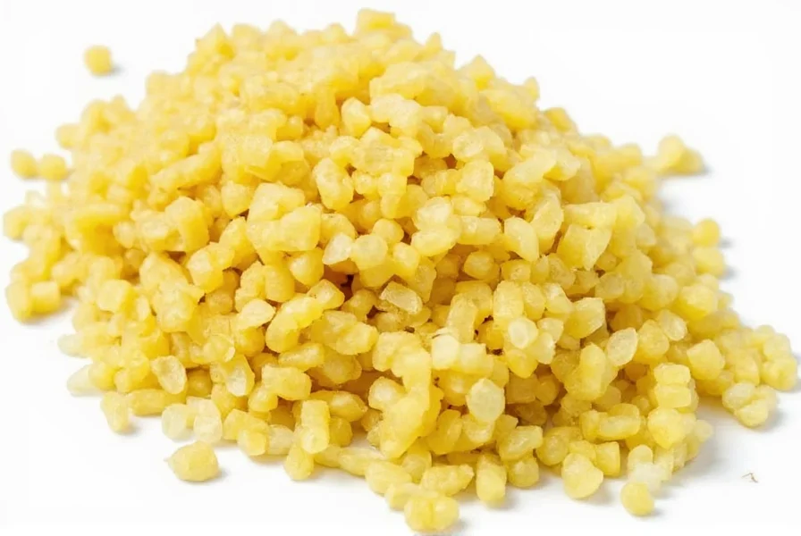 Minced ginger root being added to stir-fry in wok with vegetables