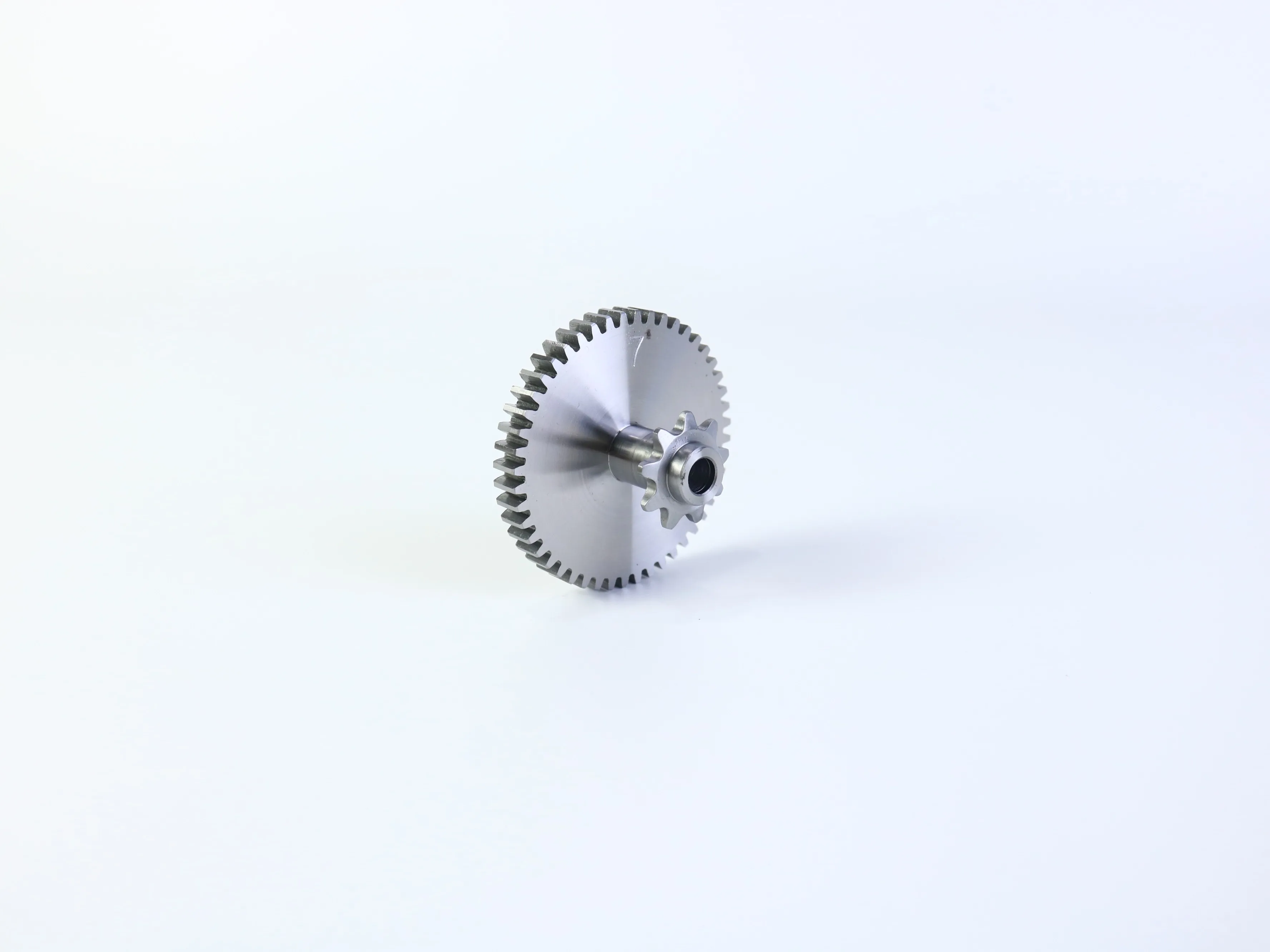 CNC machined gear and shaft-related component shown on a light background