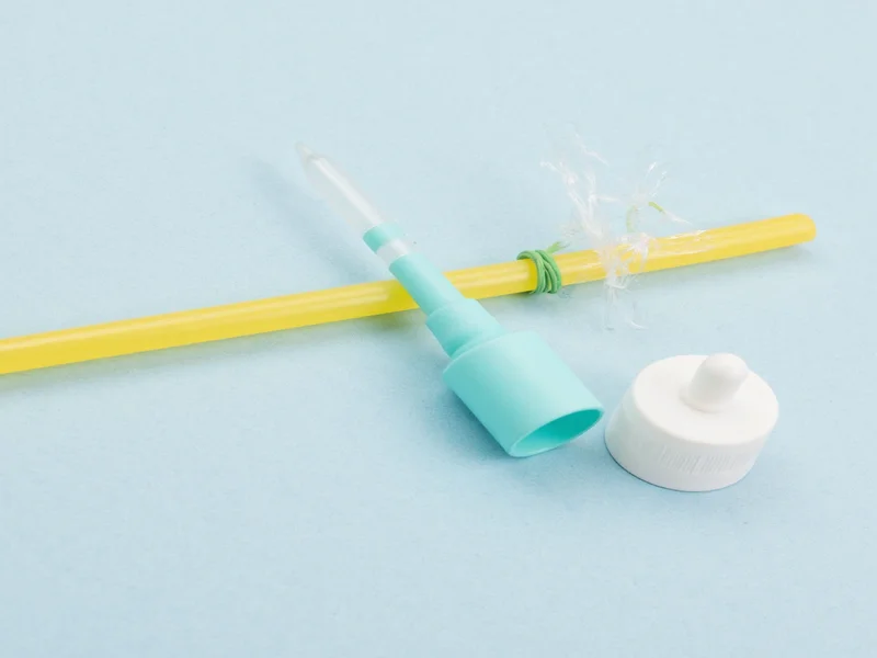 Recycled materials for DIY dropper: plastic cap, straw, rubber band