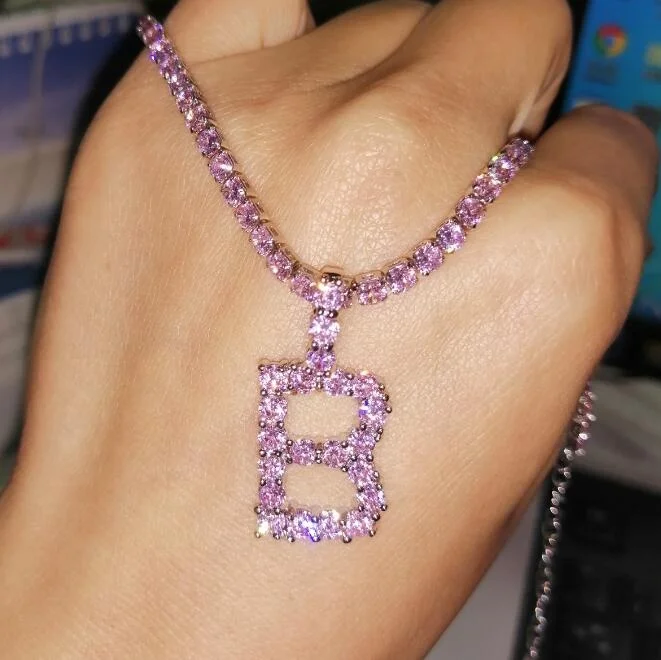 

pink iced out initial necklace