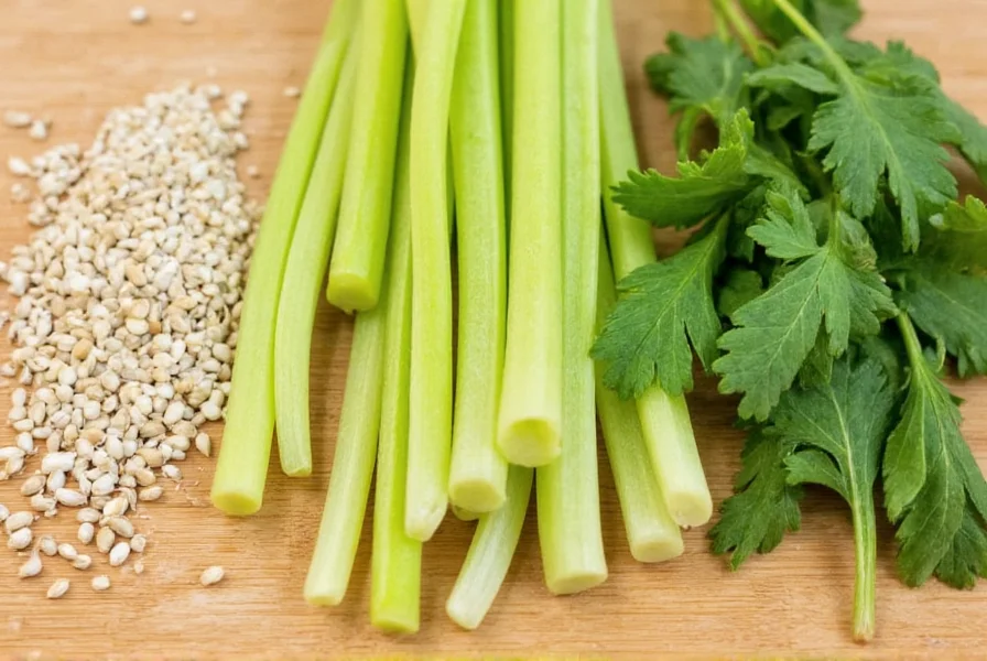 Close-up comparison of celery seeds, fresh celery stalks, and lovage leaves on wooden cutting board