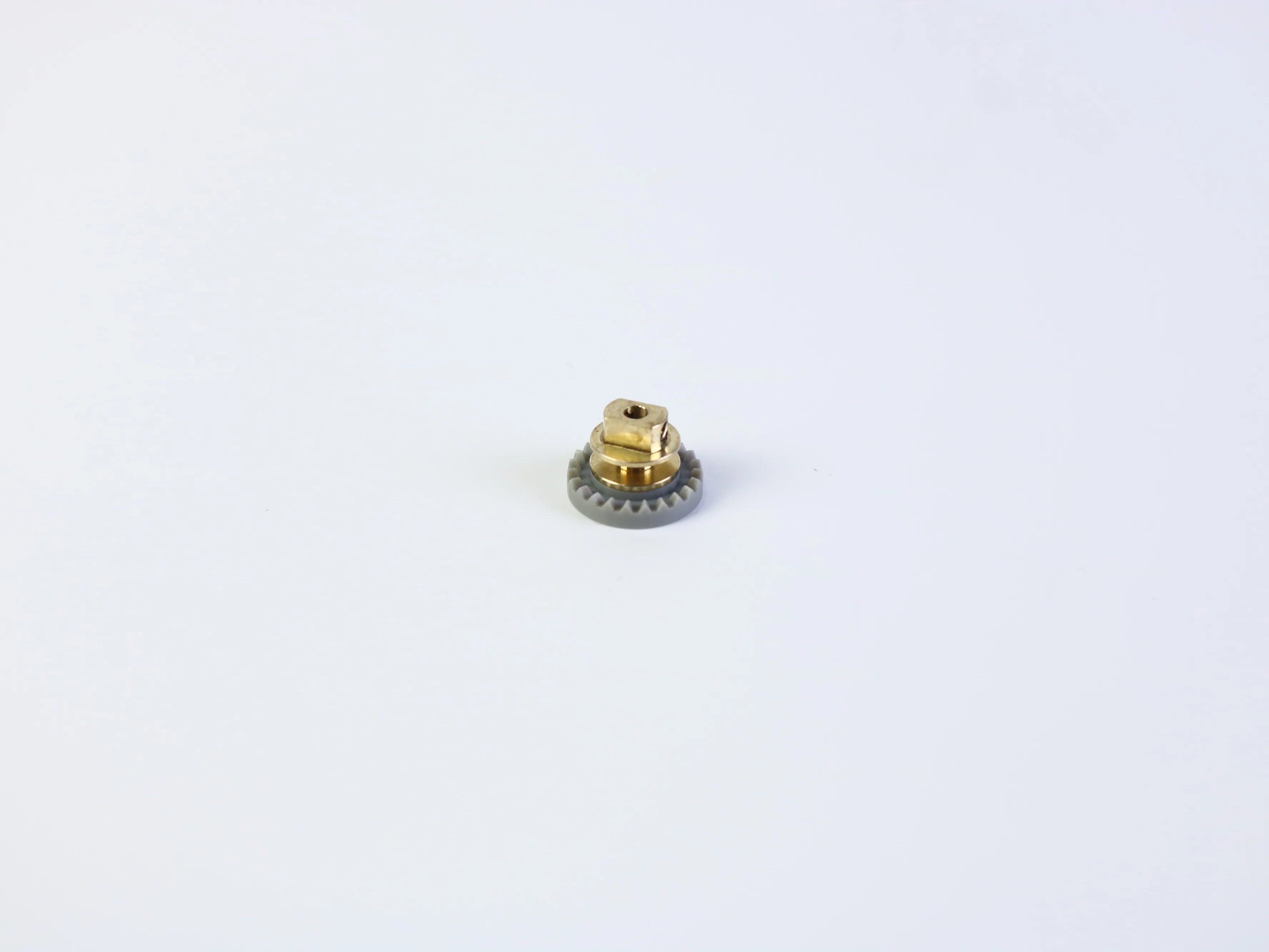 Small machined gear component with a central mounting feature