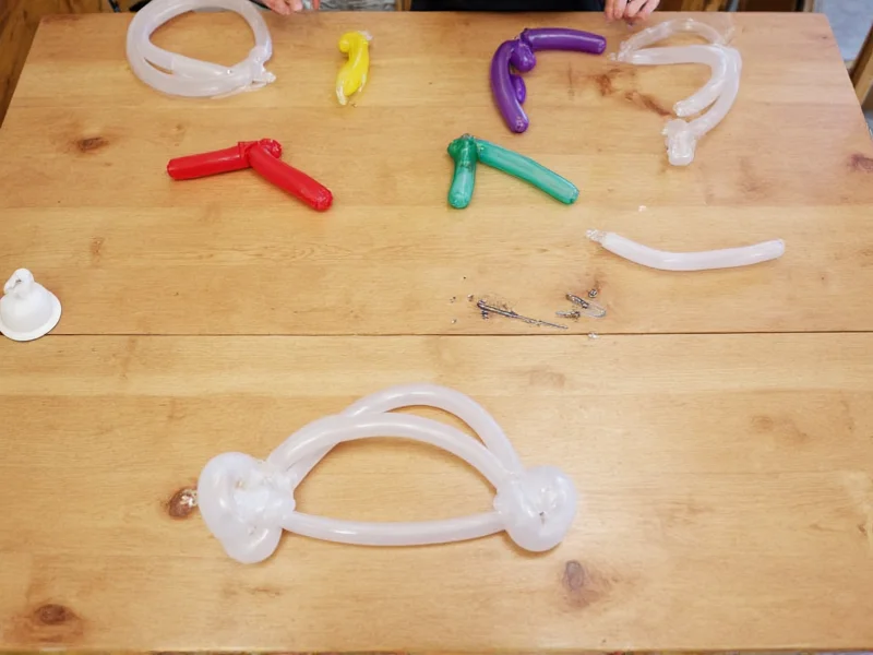 Balloon strip assembly on wooden table with color-coded sections