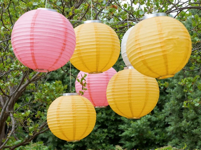 Eco-friendly paper lanterns displayed in garden party setting