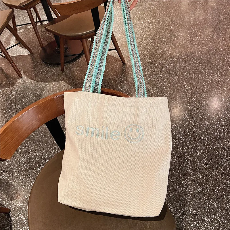 

2021 Summer Fashion Korea Custom Embroidery Smile Large Capacity Students for School One Shoulder Canvas Bag Wholesale, Customized color