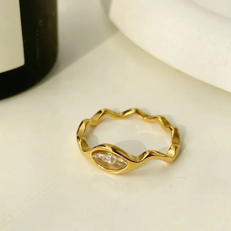 

Stainless Steel Slim and Irregular Wave Curve Eyes Zircon Ring Titanium Steel Electroplated 18k Gold Ring