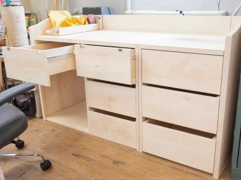 DIY craft armoire with roll-out work surface and modular drawer system