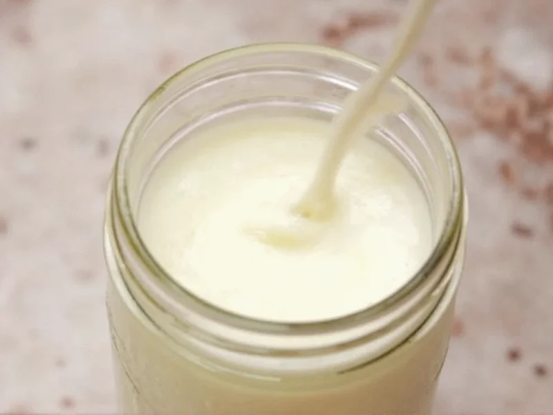 Shaking heavy cream in mason jar during butter making process