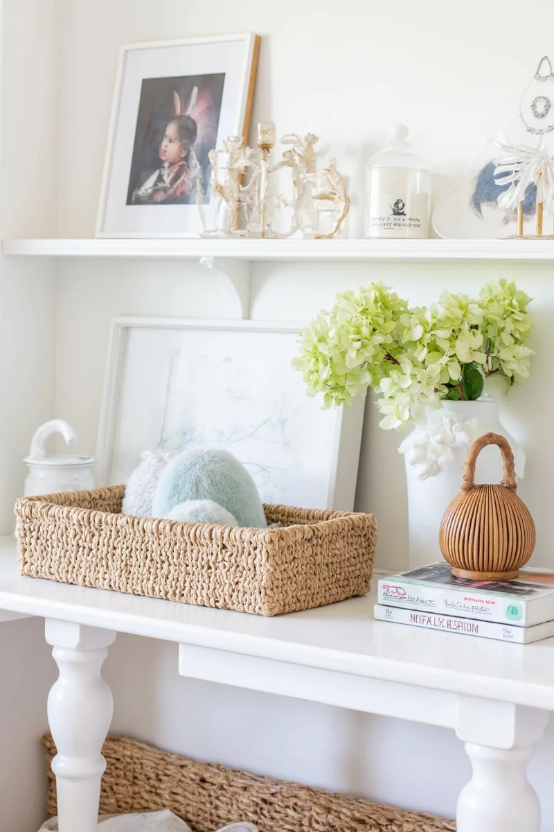 A rustic-style bunny hideout made from natural wicker and lined with soft grey fabric, blending into a farmhouse-themed living room.