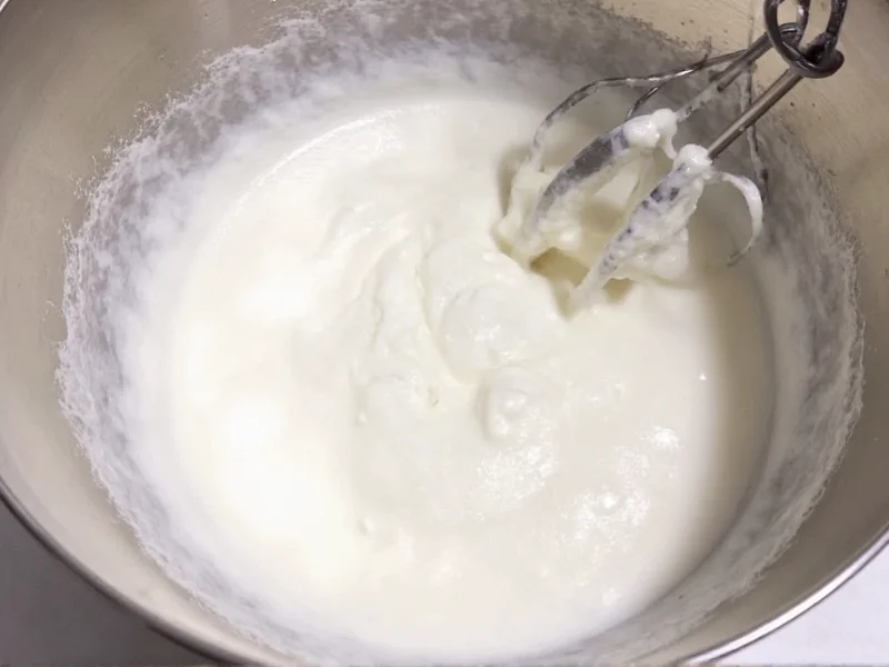 Whipping cream to stiff peaks in chilled metal bowl